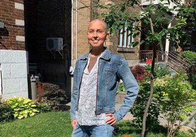 Nadia Chaudhri stands in front of a building at Concordia University.